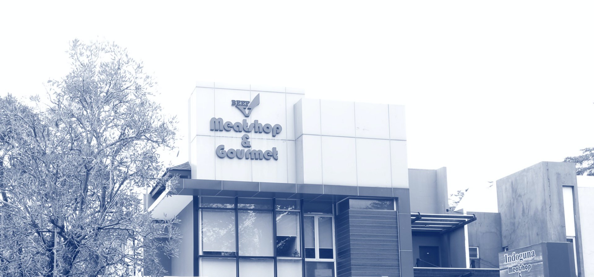 Meatshop Indoguna storefront exterior (B&W wide)